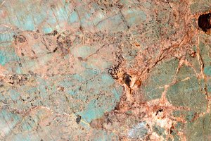 A green-turquoise granite with white veins.