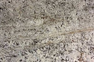 A beige granite with black, grey and yellow spots.