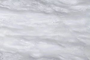 A white marble with soft horizontal gray movement.