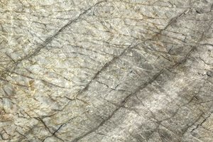 A beige granite with soft diagonal veining and delicate, web-like movement.