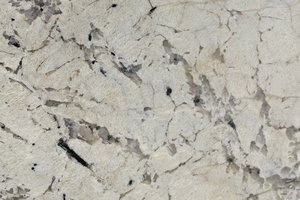 A beige and white granite with gold and grey veins.