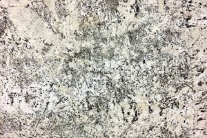 A creme granite with flecks of auburn and medium crystal grains.