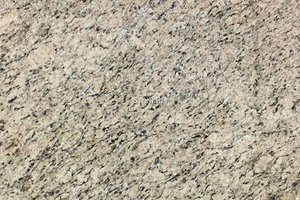 A beige granite with yellow variations and flowing grains of brown and black