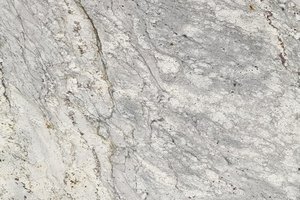 A light gray and white granite with subtle movement and dark speckling.