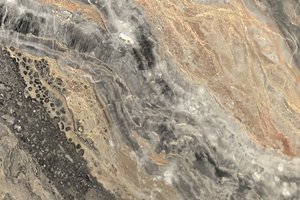 A dramatic gray marble with sweeping bands of charcoal, taupe, and warm rust movement.