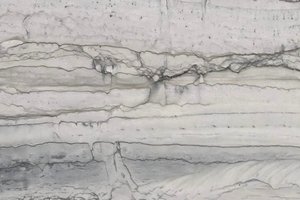 A white granite with layered gray banding and soft linear movement.