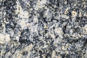 A blue-gray granite with dense mineral movement and soft cream accents.
