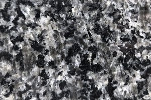 A dark gray granite with fine, evenly distributed black and light gray speckling.