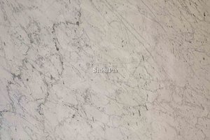 A white marble with a veining pattern.