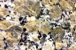 A beige granite with white and black colors in a speckled pattern.