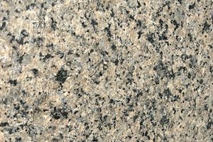 A tan granite with dense black and gray mineral speckling.