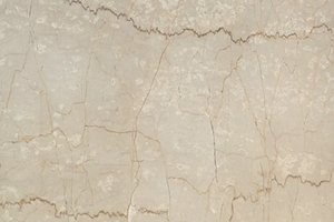A light beige marble with soft horizontal veining and subtle cream mottling.