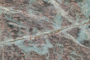 A deep green granite with bold mint and white veining.