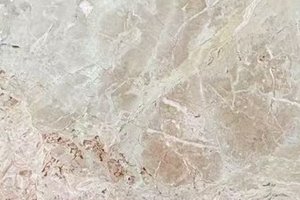 A light beige marble with soft blush tones and fractured, layered patterning.