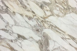 A fine grained, white and grey marble with veins.