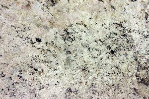 A light cream granite with black speckles and grey veins.