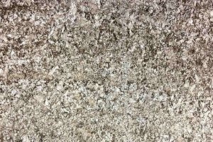 A cream granite with grey and brown flecks.
