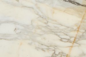 A white marble with gray and warm gold accents.