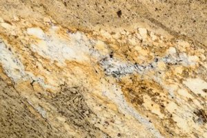 A gold and cream granite with layered movement and speckled mineral texture.