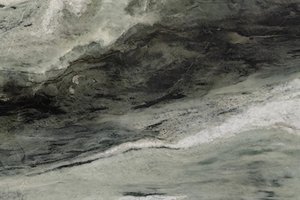 A light green marble with flowing white and dark green veining.