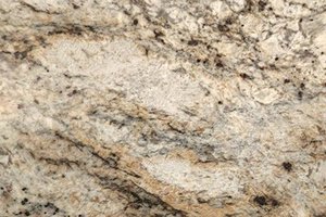 A beige and cream granite with gold tones, dark accents, and bold movement.