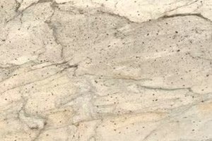 A light cream granite with fine gray speckling and soft linear movement.