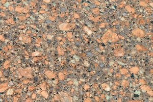 A reddish-brown granite with copper, rust, charcoal, and black speckling.