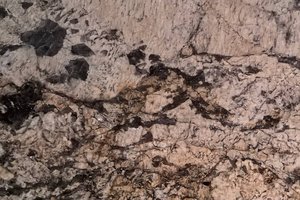 A brown granite with red and grey veining pattern.