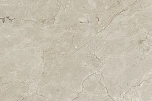 A light beige marble with soft tonal variation and subtle hairline fissures.