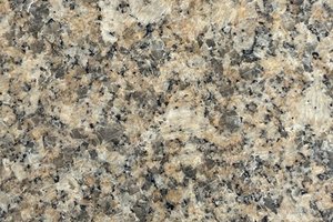 A beige and gold granite with fine mineral patterning.