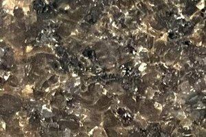 A brown granite with dense, fine crystalline patterning and subtle tonal variation.