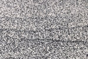 A gray granite with fine, even grain and subtle horizontal movement.
