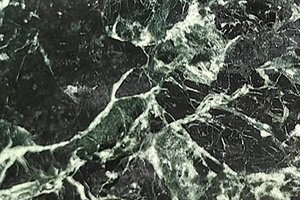 A dark green marble with layered movement and fine white veining.