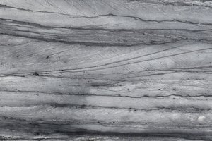 A blue granite with sweeping charcoal banding and subtle silver movement.