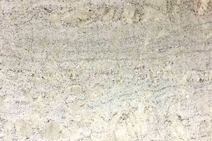 A cream and white granite with random spots.