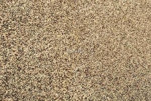 A brown and gold granite with a grained texture.