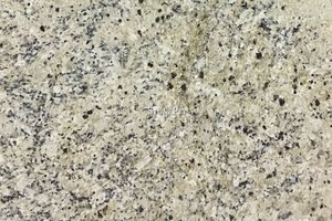 A beige and white granite with auburn and black flecks