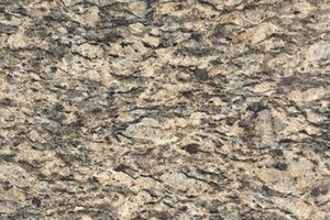 A gold and beige granite with layered mineral movement.