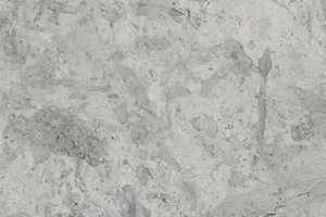 A light gray limestone with soft tonal variation and subtle organic movement.