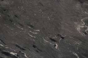 A dark charcoal granite with flowing white and gray bands and strong linear movement.