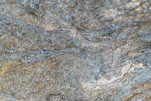 A blue granite with sweeping movement and warm gold accents.