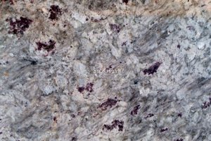 A white granite threaded with black and grey.