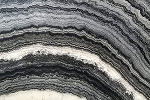 A black marble with sweeping gray and white banded layers.