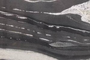 A black granite with flowing white movement and soft tonal contrast.