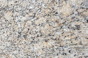A white granite with yellow variation and black veining