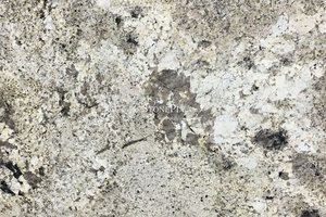 A beige granite with white variations and tan, grey and brown veining.