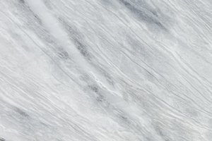A white granite with flowing gray veining and soft linear movement.
