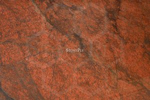 A red-brown granite with a medium texture.