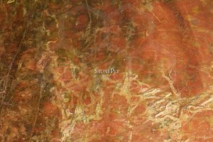 A fine grained, red marble with white or yellow veins.