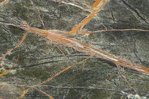 A dark green marble with dense texture and bold rust-toned veining.